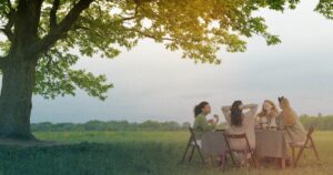 Women conversing under a tree for This Medical Life Menopause episode